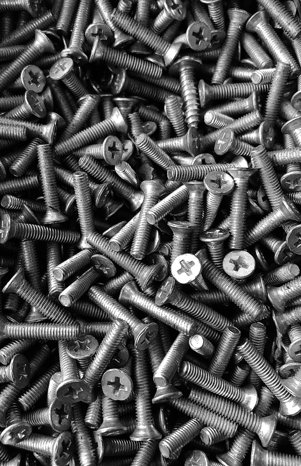 Silver screws on wooden table for Epo-Weld™ HTB high temperature bonding adhesive thread locking and sealing application
