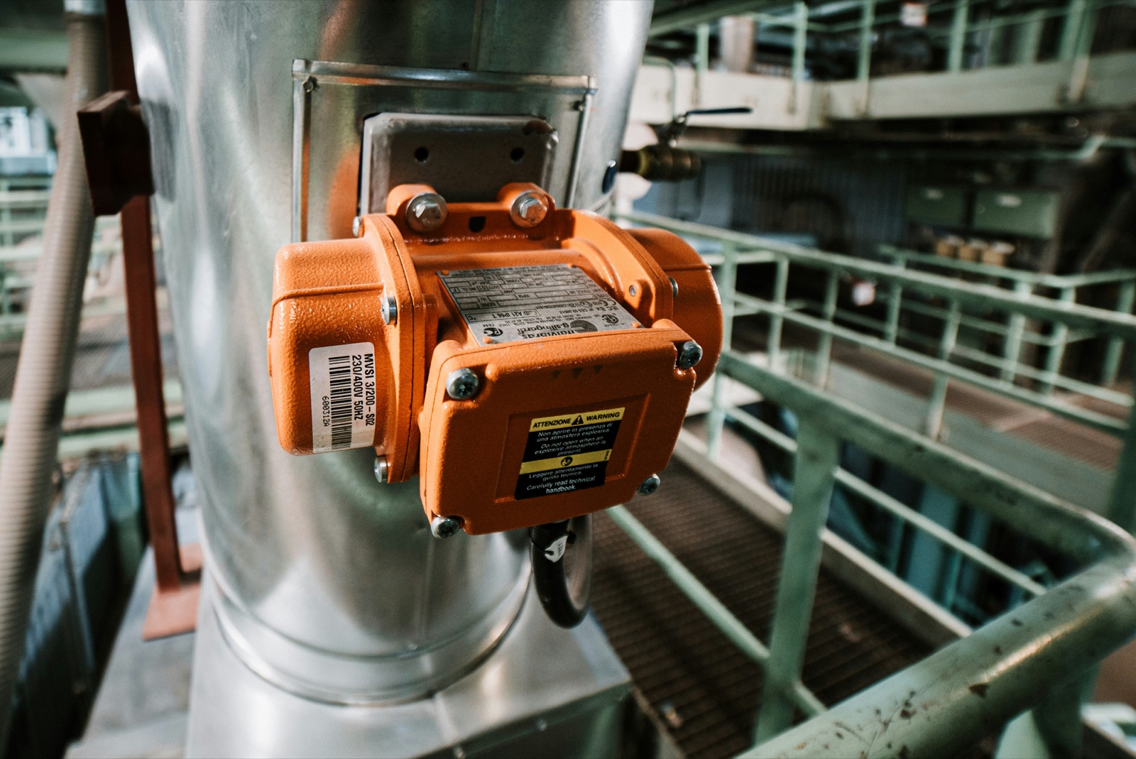 Orange industrial sensor housing mounted on metal ductwork for Epo-Weld™ HTC high temperature coating protection