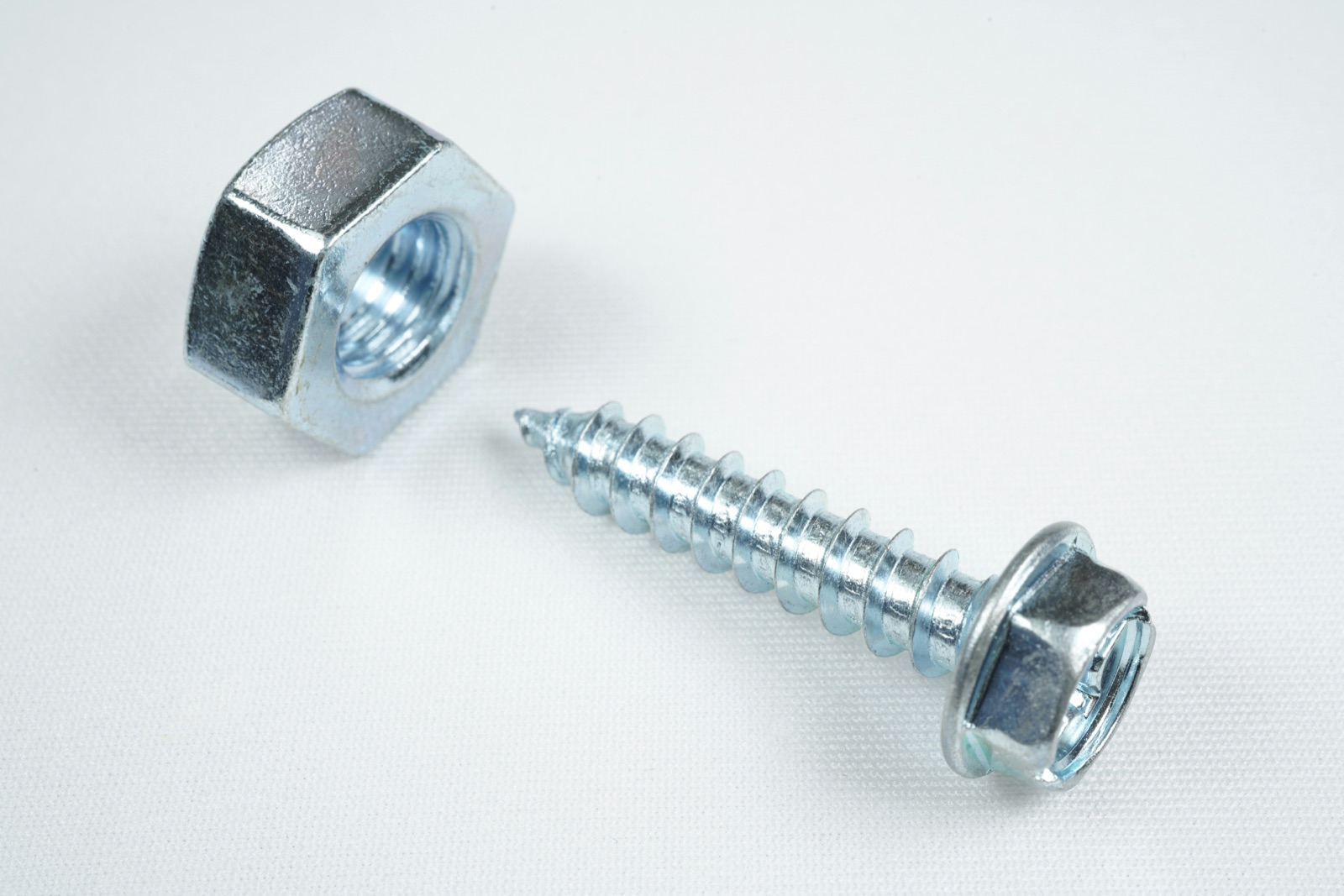 Silver screw on white surface for Epo-Weld™ TEC conductive epoxy aerospace electronics and sensor assembly