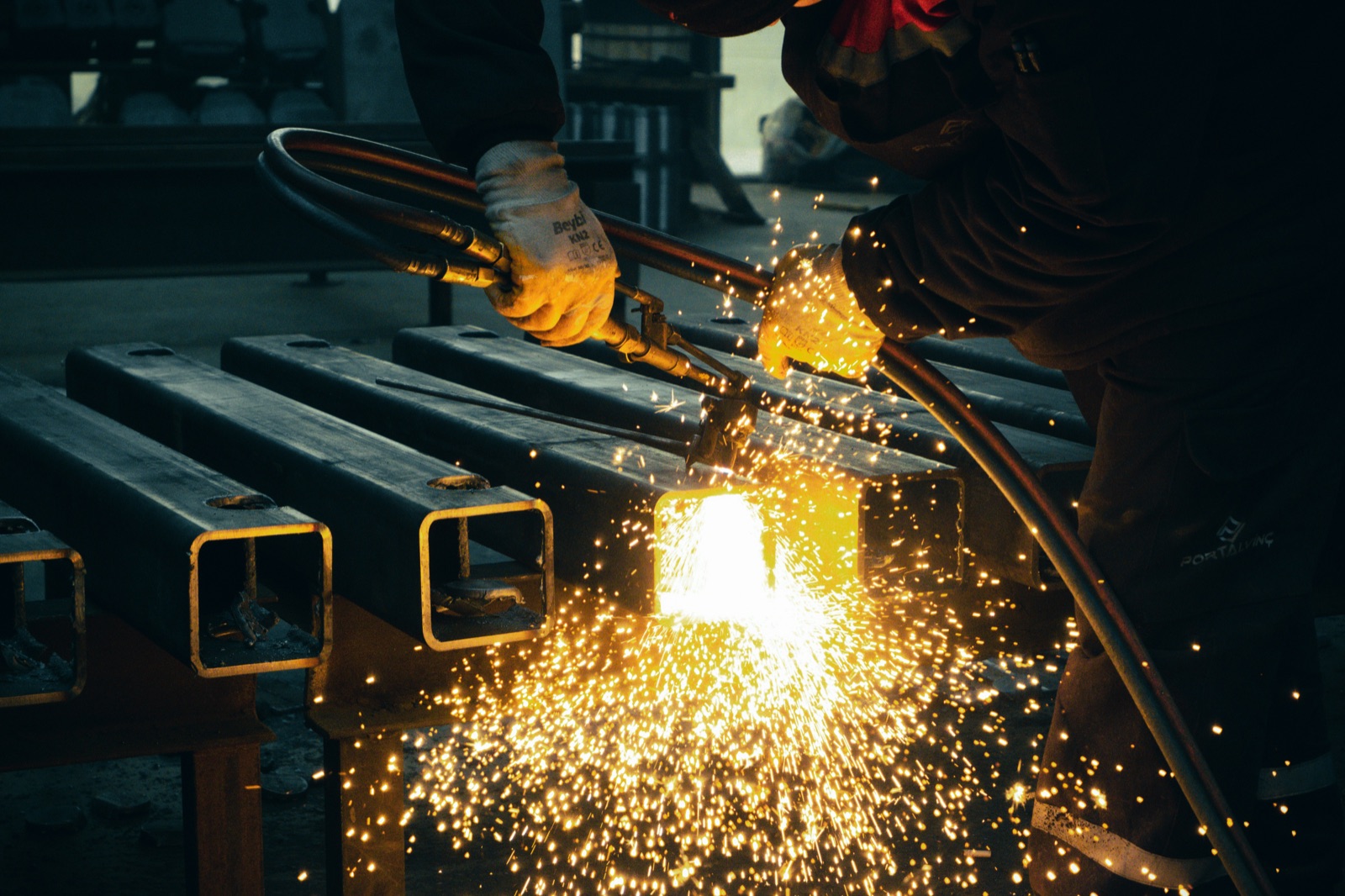 Welder with bright sparks on steel tube for Epo-Weld™ inorganic binder thermal spray and plasma sealing