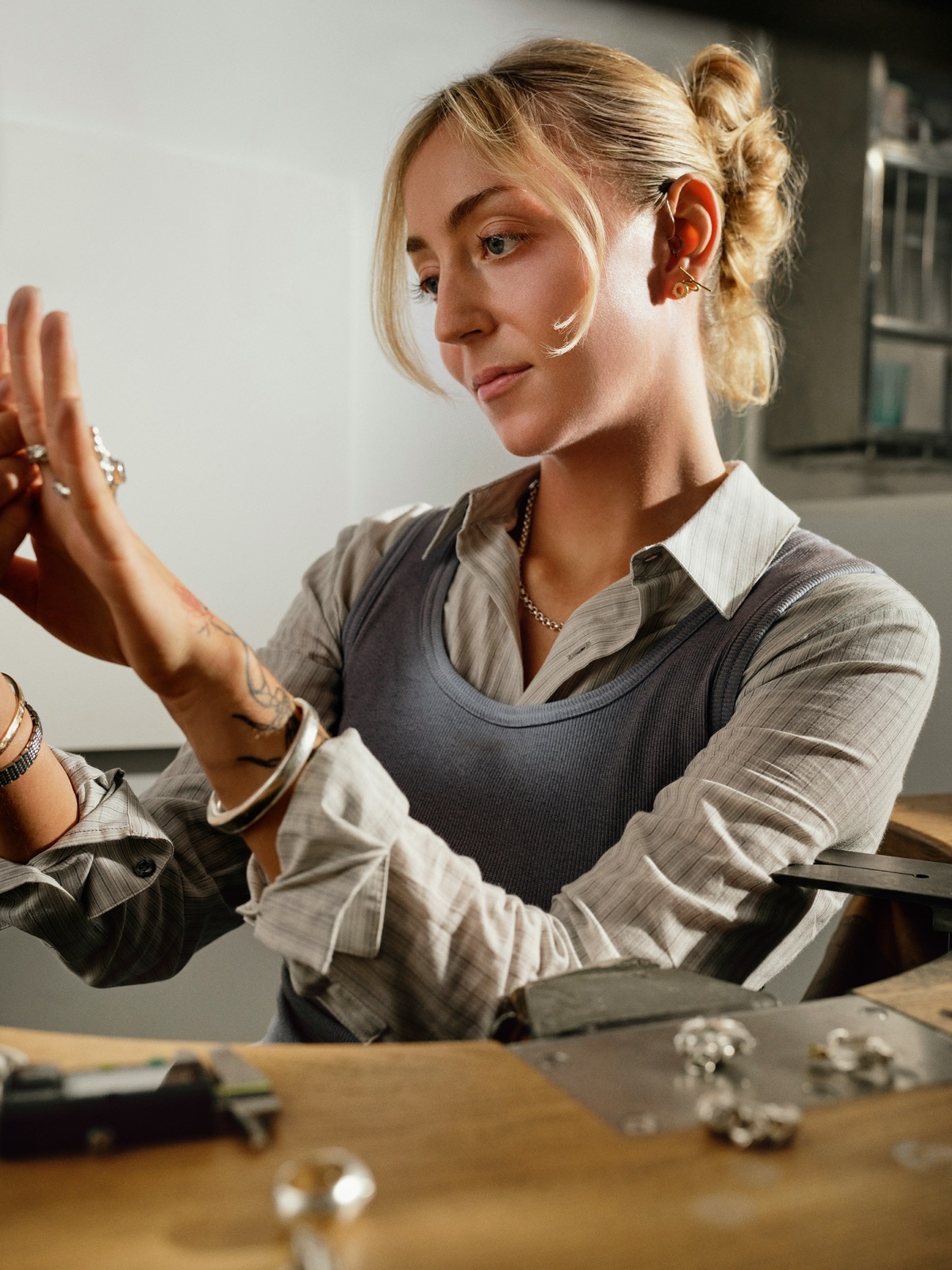 Jeweller examining silver ring with metal components for Incure Sniper™ jewellery adhesive