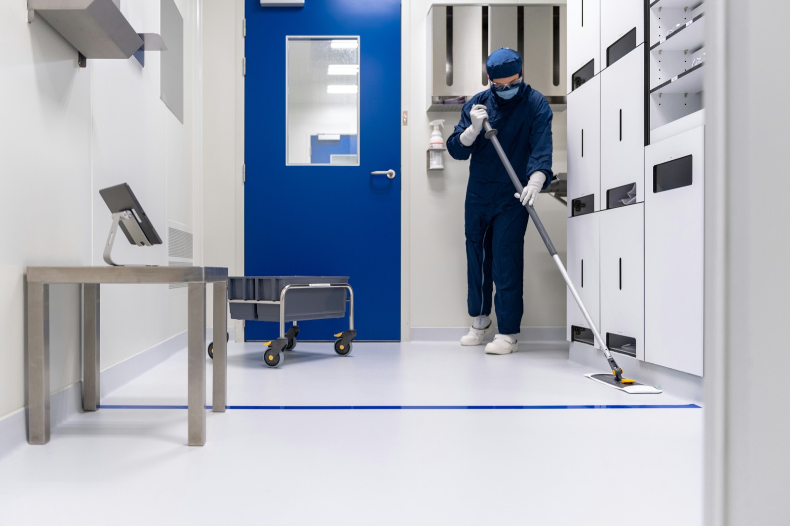 Cleanroom worker in protective suit at pharmaceutical facility for Incure Sniper™ medical device assembly