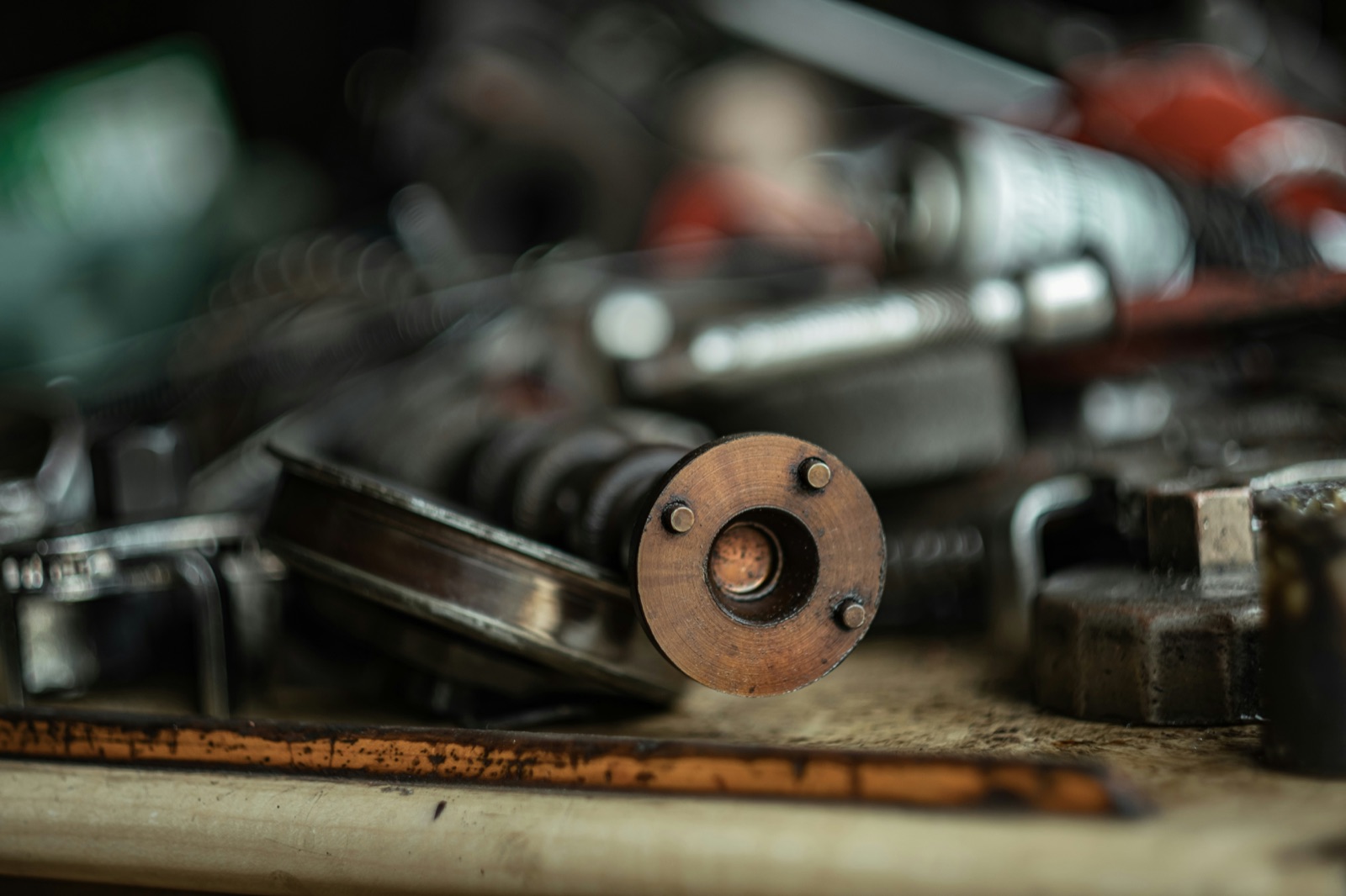 Industrial mechanical parts and tools on a workbench for Pyra-Sil™ RTV silicone mechanical assembly and gasketing