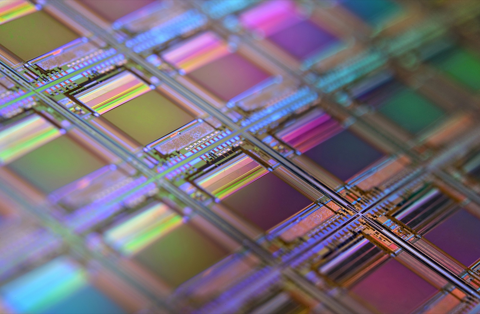 Iridescent semiconductor wafer showing die surfaces for Ultra-Illumina™ UV conformal coating component encapsulation