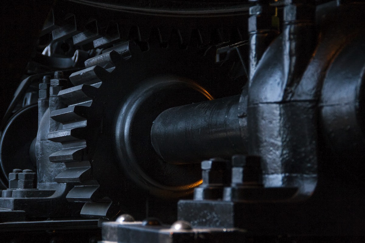 Close-up of large metal gears and mechanical components for Quad-Cure™ structural bonding in high-vibration assemblies