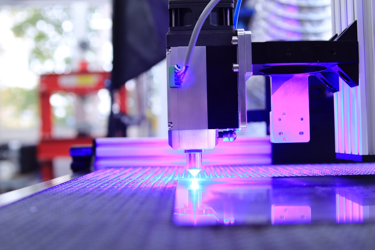 Purple UV laser light from CNC optical system for Uni-Seal™ UV gasket dam-and-fill and active alignment fixturing