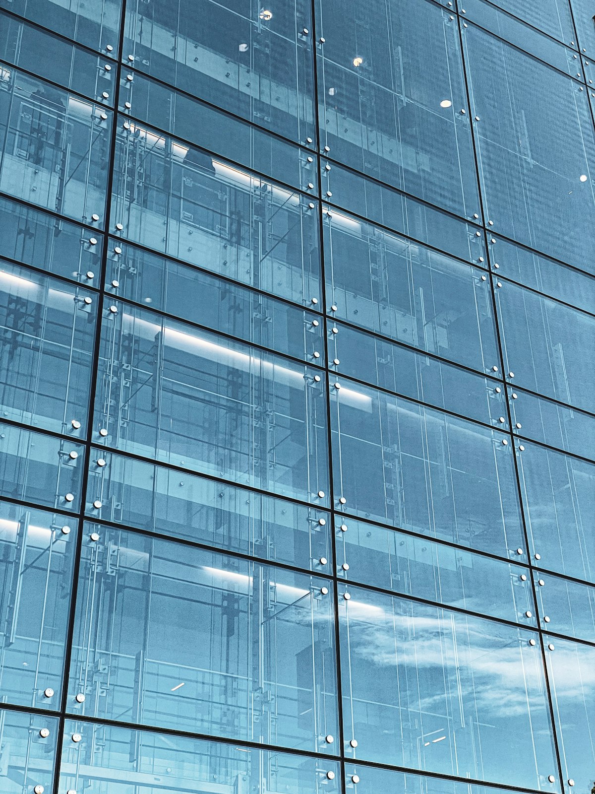 Modern glass facade building with geometric panel grid for Uni-Seal™ UV gasket non-sag vertical glass bonding