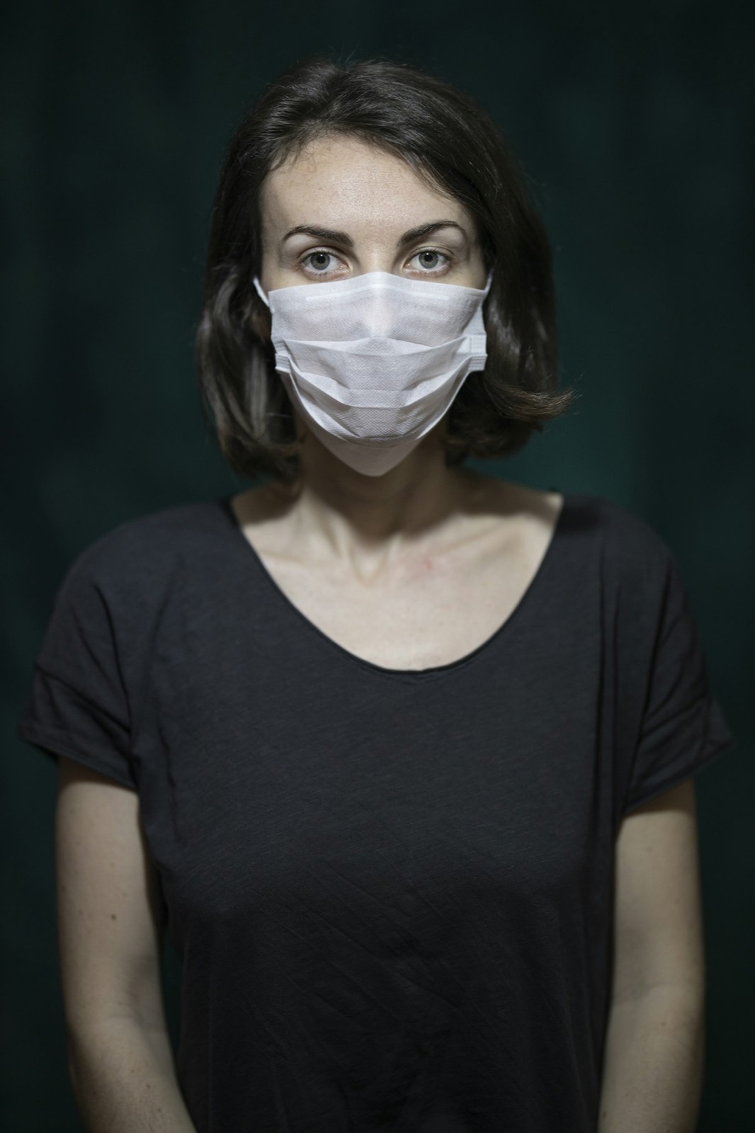 Woman wearing white medical face mask for Cyro-Weld™ UV medical adhesive respiratory mask filter bonding and valve