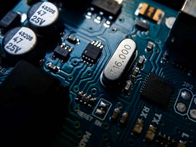 Close-up of teal circuit board with integrated chips and sensor components for Optik™ UV LiDAR sensor module assembly