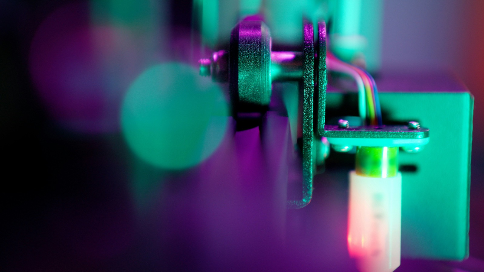 Electronic component assembly under purple-teal UV light for Pyra-Sil™ UV silicone electronics potting and encapsulation